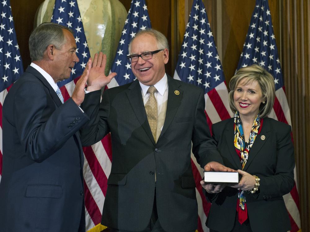 Then-House Speaker John Boehner of Ohio administers a ceremonial re-enactment of the House oath-of-office to then-Rep. Tim Walz, as Gwen watches, in 2015. 