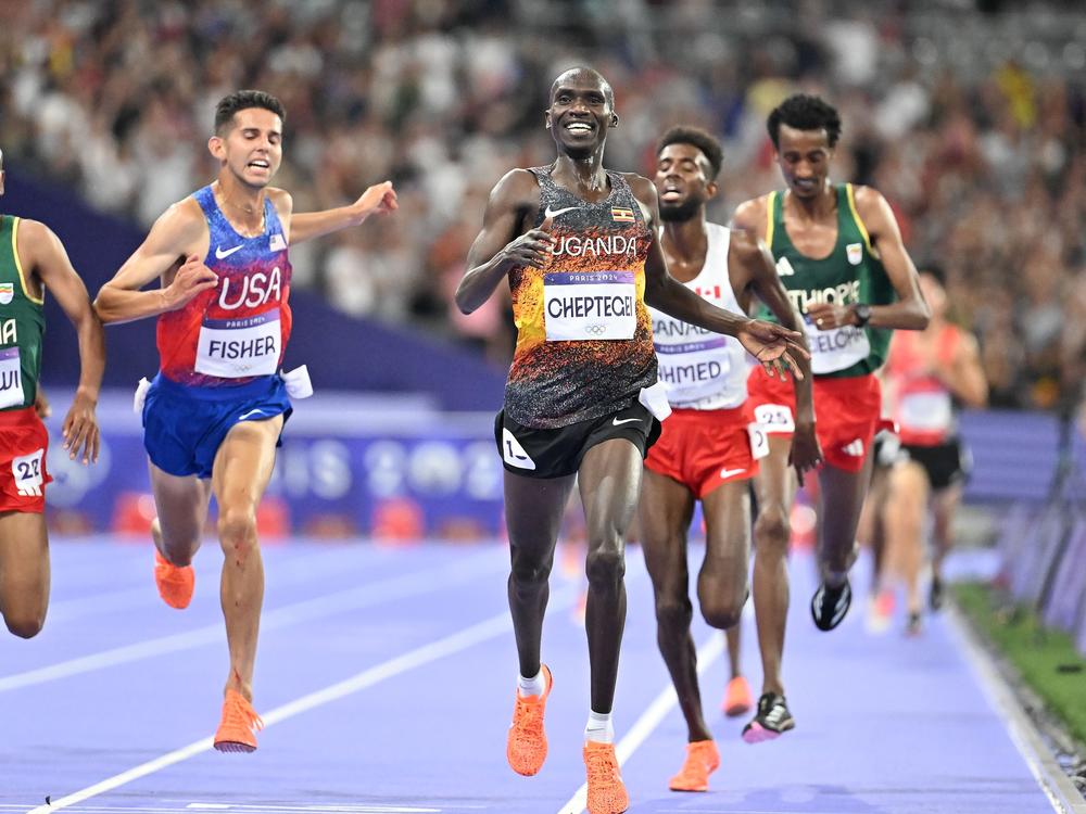 Joshua Cheptegei of Uganda crosses the finish line during the men's 10,000-meter final at the Paris 2024 Olympic Games, setting an Olympics record.