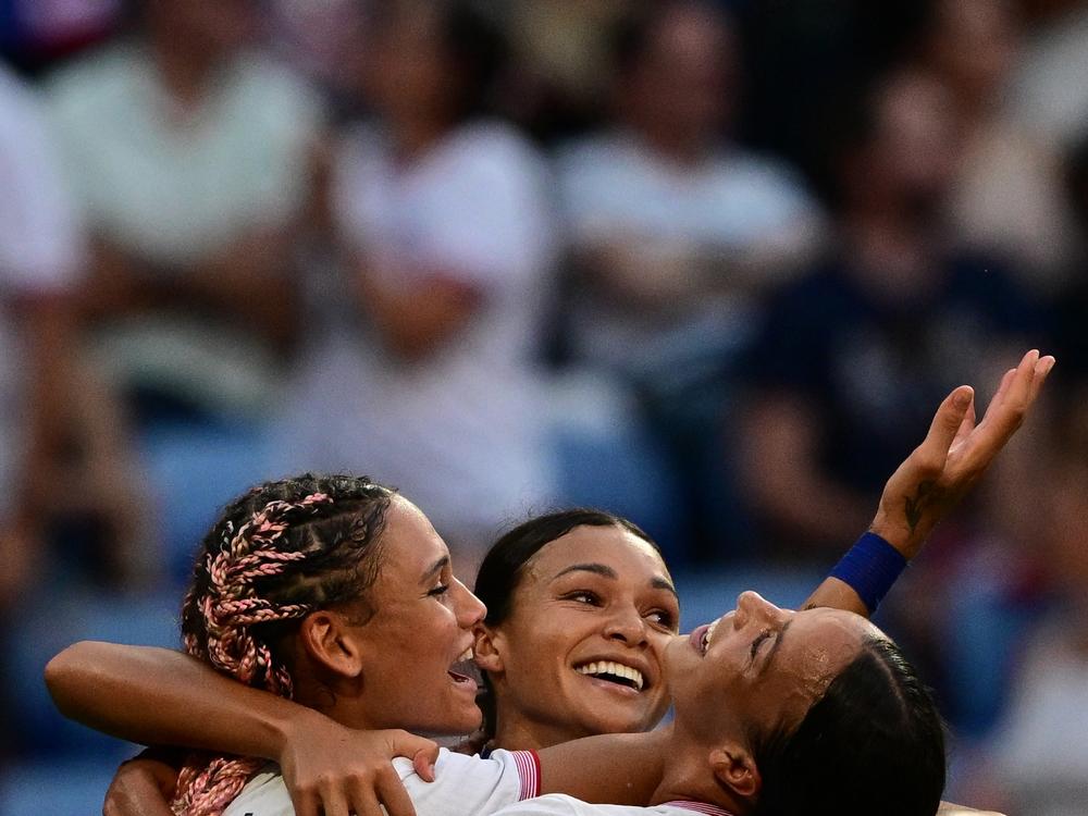 U.S. forward Trinity Rodman (L) and Mallory Swanson (R) celebrate after Sophia Smith scored in the 95th minute during the women's semifinal match Tuesday against Germany to advance to the gold medal game at the Paris Olympic Games.