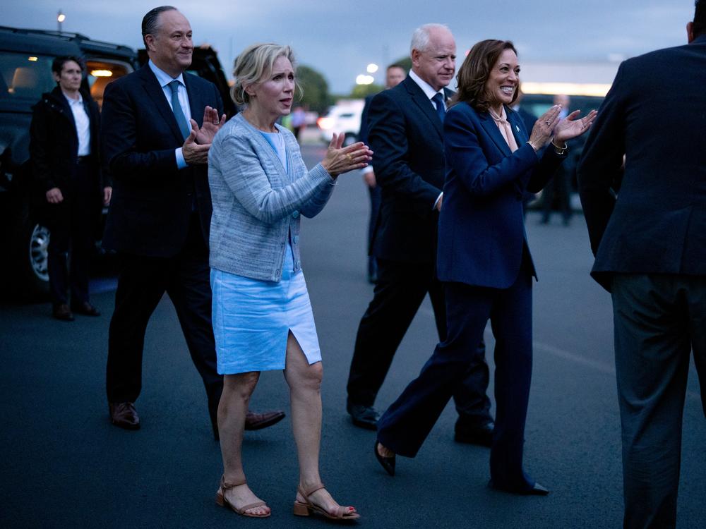 Second gentleman Doug Emhoff, Gwen Walz, vice presidential candidate Tim Walz and presidential candidate Kamala Harris walk across the tarmac at Philadelphia International Airport after their first rally together on Tuesday. 