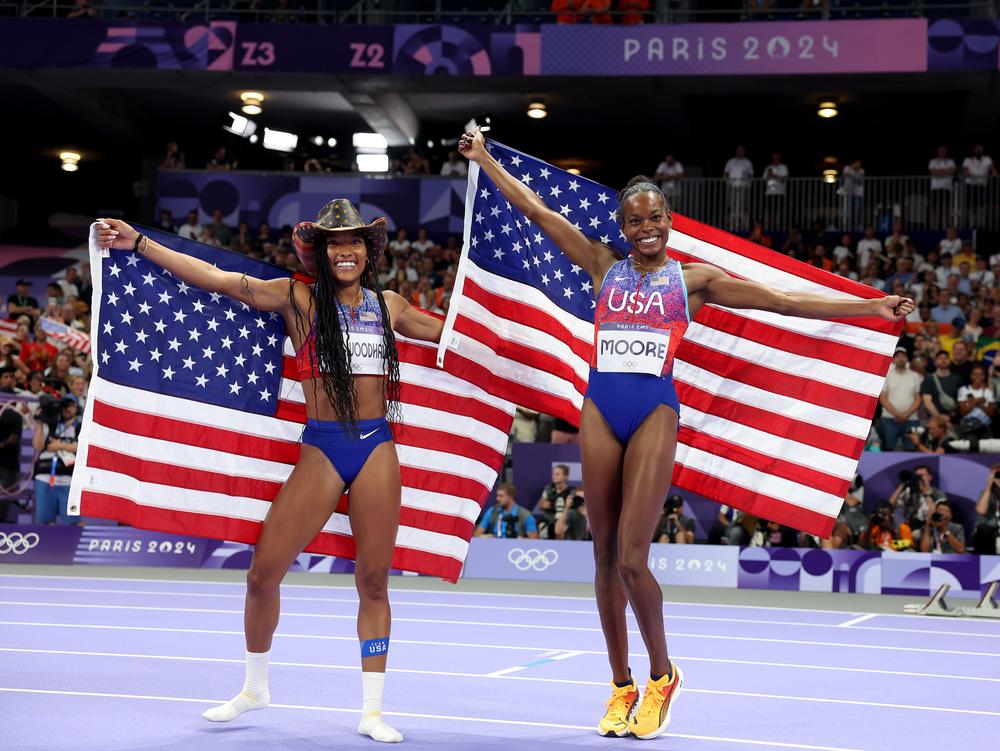 Bronze medalist Jasmine Moore (R) and gold medalist Tara Davis-Woodhall (L) of Team USA celebrate after the women's long jump final on Aug. 8 in Paris.