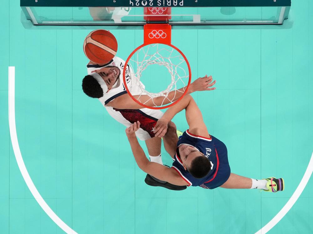 Devin Booker #15 of the USA shoots the ball during a semifinal game against Serbia. The U.S. trailed for most of the game but stormed back to win 95-91.
