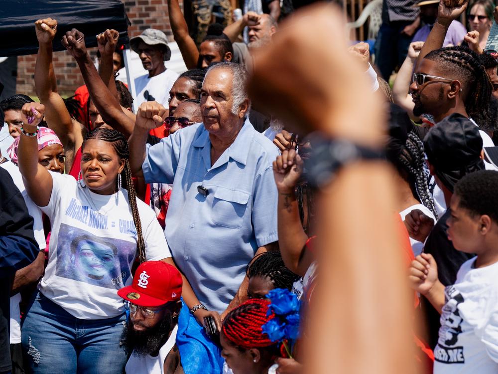U.S. Rep. Cori Bush, D-St. Louis County, rests her arm on Michael Brown Sr. 