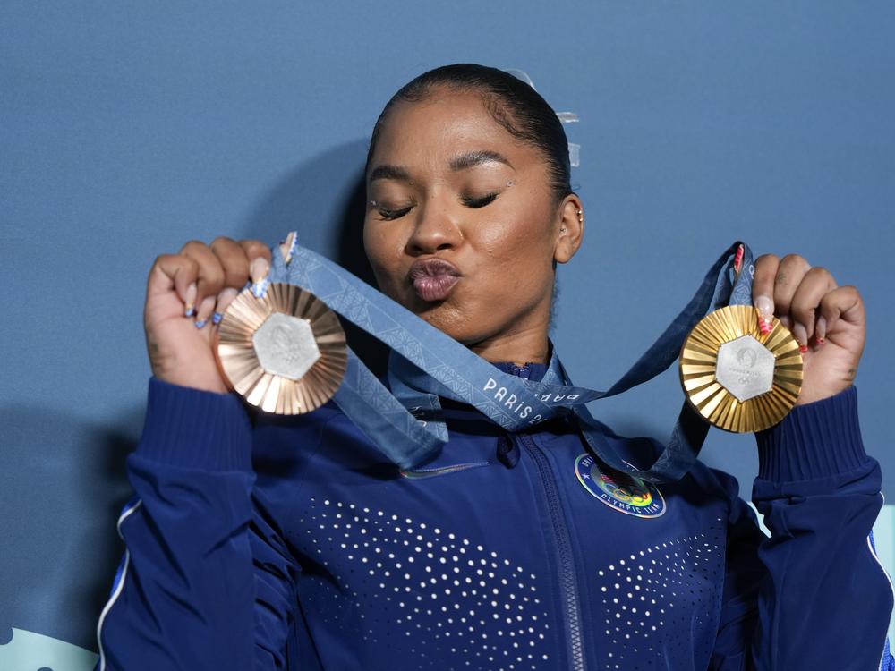 U.S.'s Jordan Chiles holds up her medals after the gymnastics finals on Monday. Her bronze, on the left, which she won during the floor exercise might be taken away.