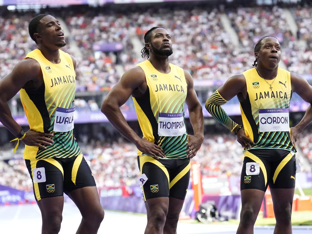 Members of Jamaica's men's 4x100-meter relay team react following their heat at the Paris Olympics on Thursday, in Saint-Denis, France.