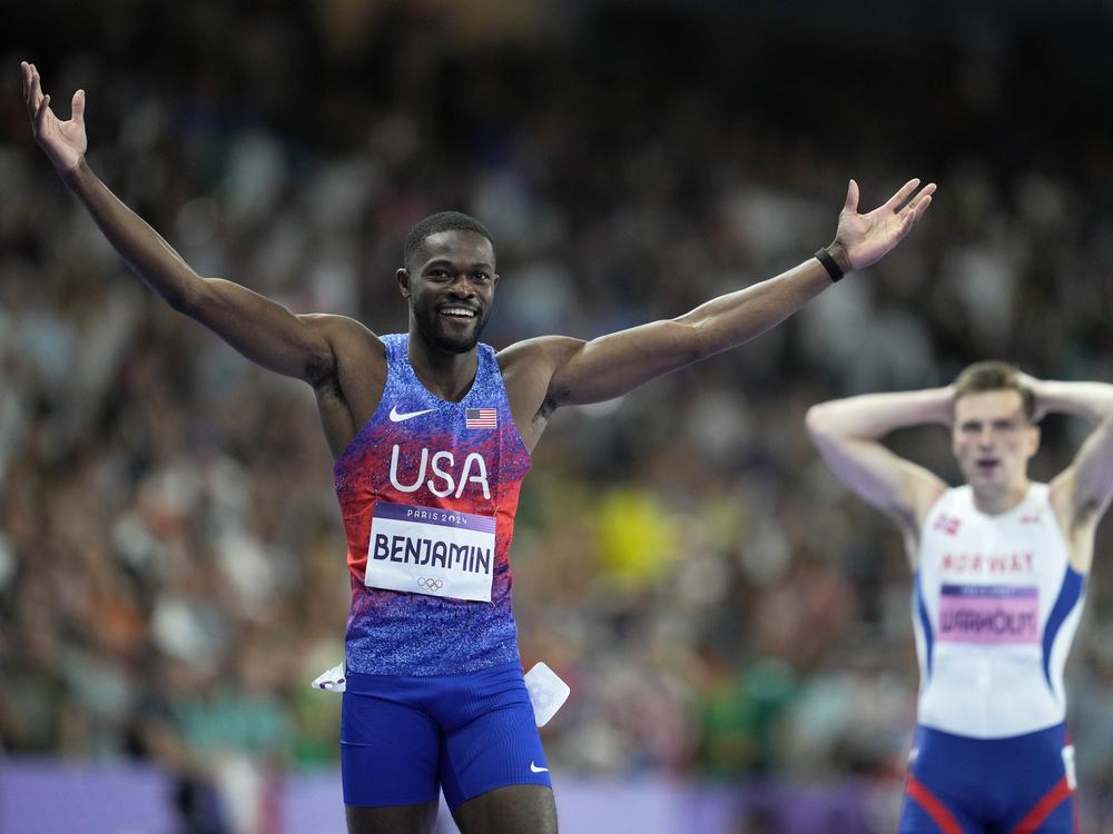 Rai Benjamin of the U.S. celebrates after winning gold ahead of silver medalist Karsten Warholm of Norway, seen behind him, in the 400-meter hurdles final at the Paris Olympics on Friday.