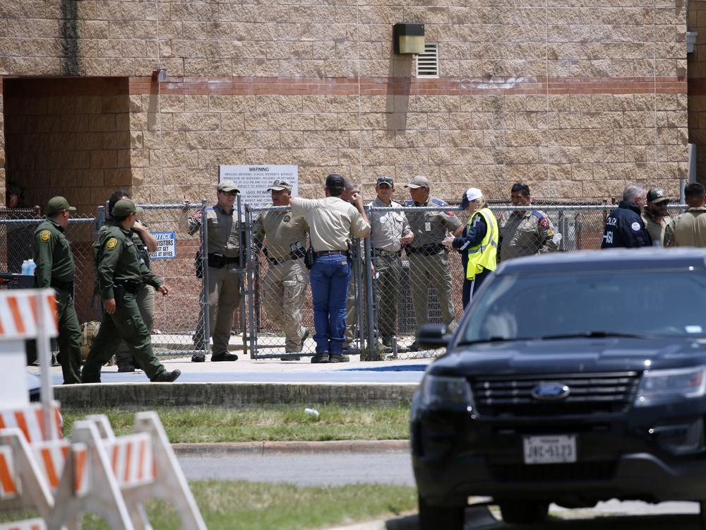Law enforcement and other first responders gather outside Robb Elementary School following a shooting, Tuesday, May 24, 2022, in Uvalde, Texas. 