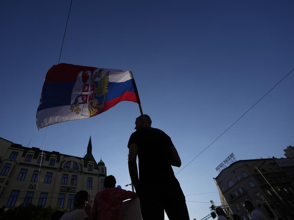 A man waves a flag combined of Russian and Serbian colors as he attends a protest against pollution and the exploitation of a lithium mine in the country, in Belgrade, Serbia, on Saturday.