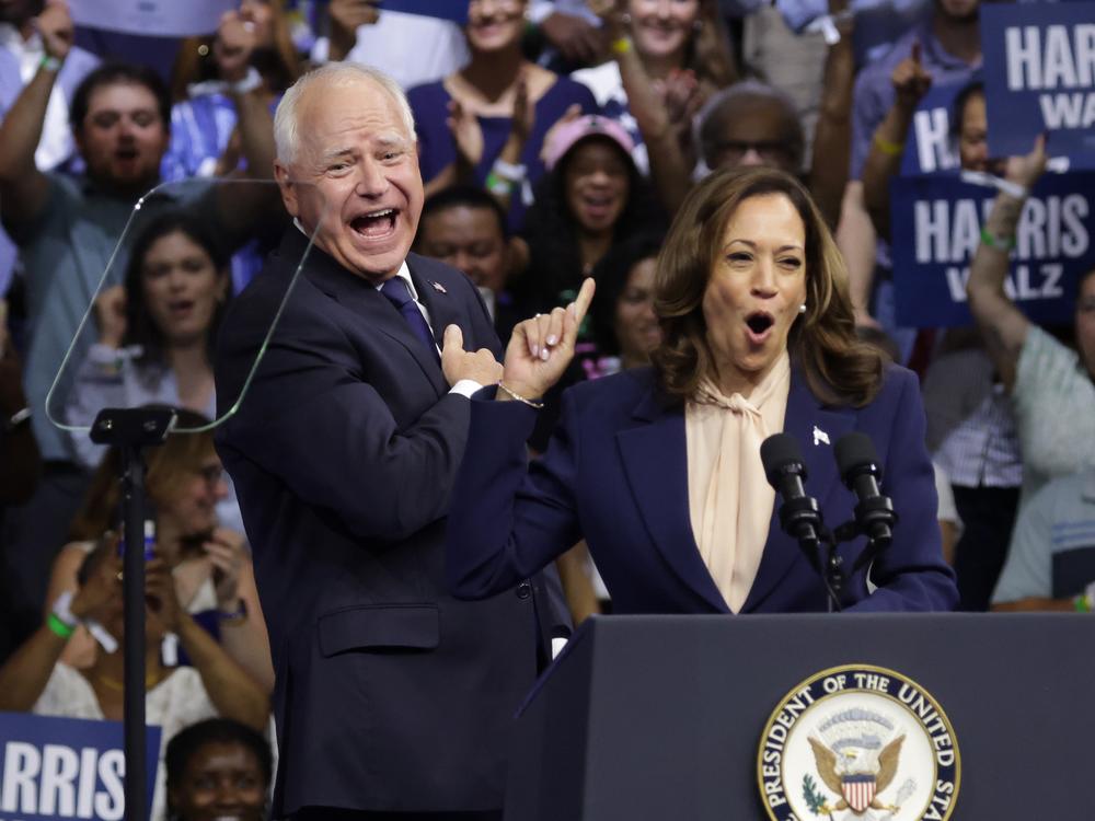 Vice President Harris (R), introduces Democratic vice presidential candidate Minnesota Gov. Tim Walz (L) during a campaign rally at Temple University on Monday in Philadelphia.