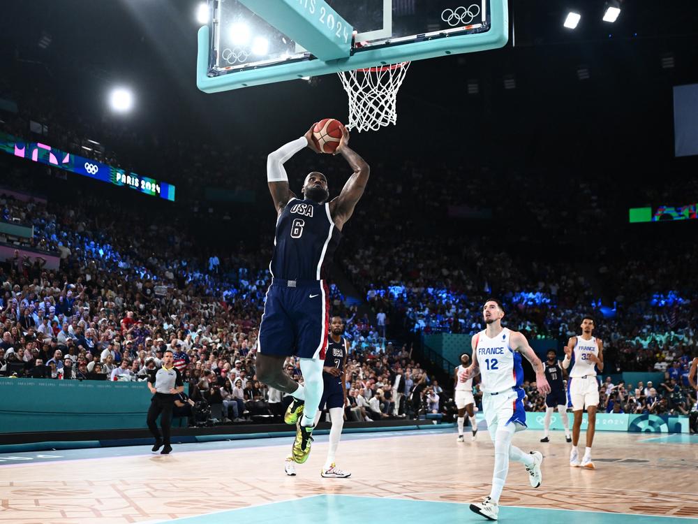 LeBron James dunks the ball during the men's Gold Medal basketball match between France and USA at the Paris Olympics on Saturday. The U.S. downed France to win its fifth straight Olympic gold medal - extending a lengthy streak of international dominance.