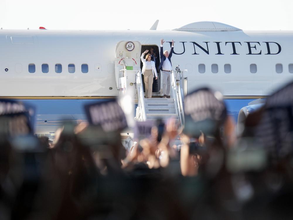 Harris and Walz walk off an aircraft after they landed at the Detroit Metropolitan Wayne County Airport for a campaign rally on Wednesday.