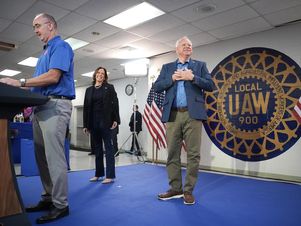 Harris (C) and Walz (R) appear at a campaign rally with U.A.W. President Shawn Fain (L) at United Auto Workers Local 900 on Thursday in Wayne, Mich.
