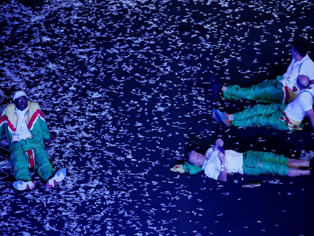 Athletes of Suriname sit on the floor during the closing ceremony on Sunday.