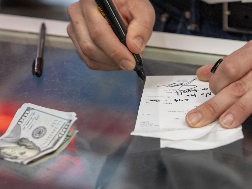 Republican vice presidential candidate Sen. JD Vance, R-Ohio, signs a check 
