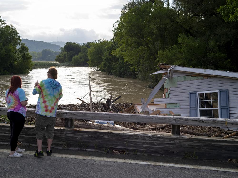 A mobile home swept from its foundation is seen lodged about 1,000 feet away from the property where it stood near a bridge on the Canisteo River, Friday, in Canisteo, N.Y., after remnants of Tropical Storm Debby swept through the area.