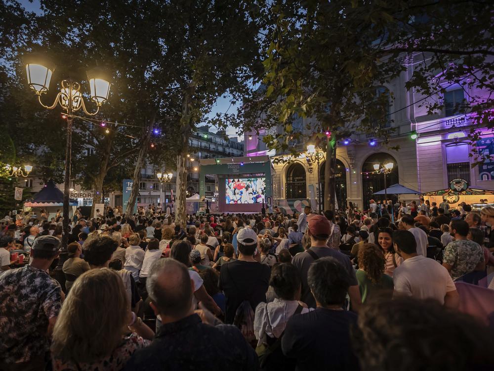 People watch a TV program airing the 2024 Summer Olympics closing ceremony on Sunday.