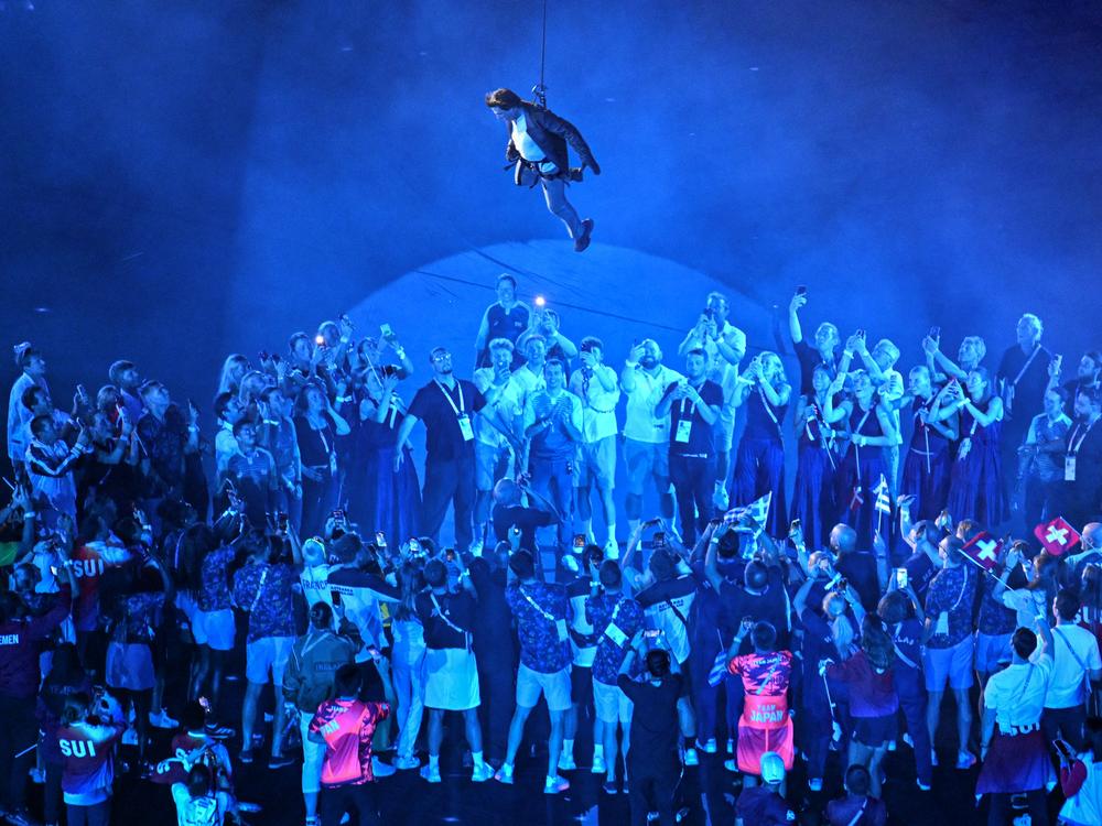 Actor Tom Cruise descends from the roof of the stadium on Sunday.