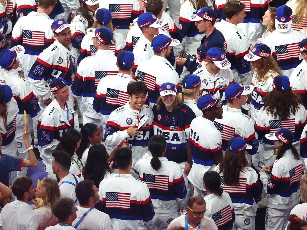 In a sea of U.S. athletes, flag bearer Katie Ledecky poses with her fellow American competitors during the closing ceremony of the Olympic Games.