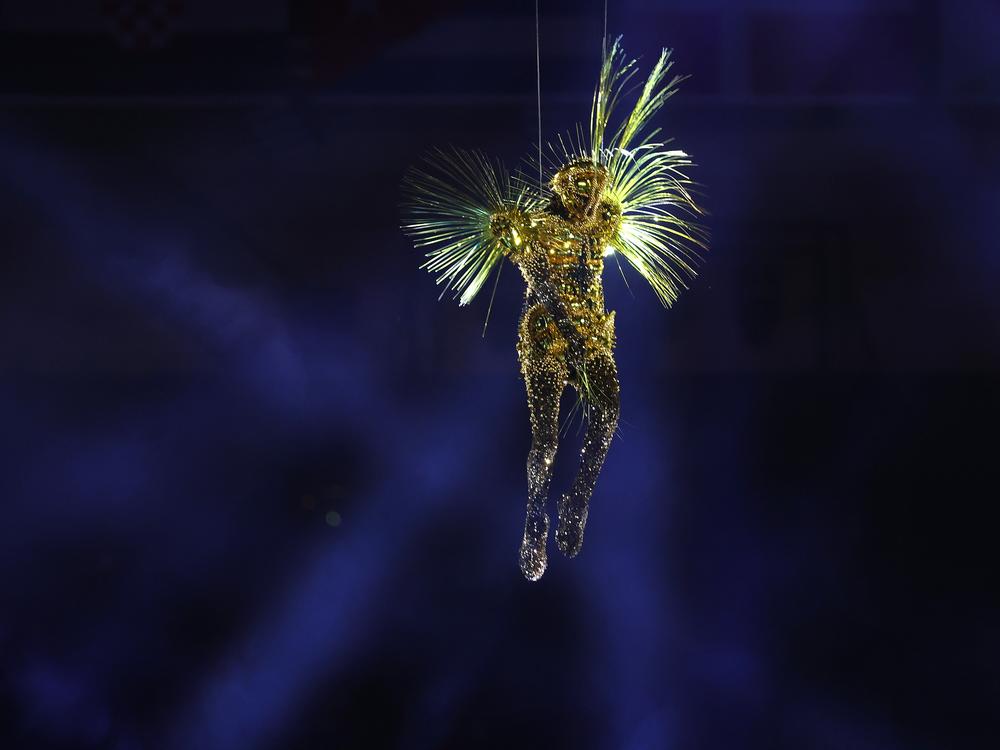 The Golden Voyager descends into the stadium as a light show takes place on Sunday.