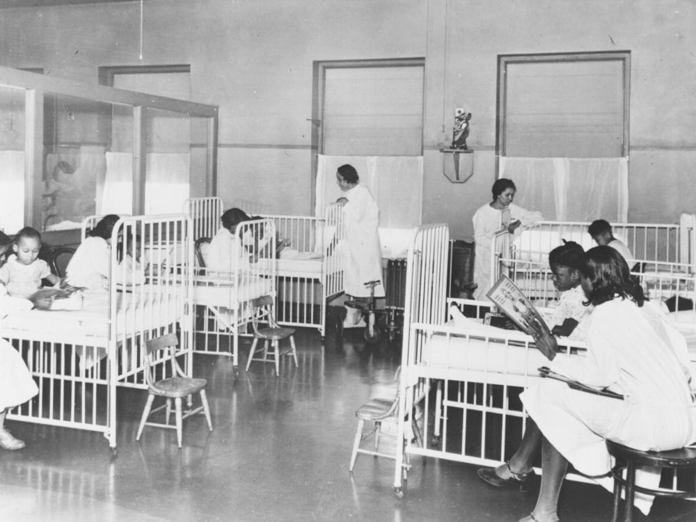 Nurses attend to patients in this historical photo of the children's ward inside Wheatley-Provident Hospital, a Black hospital in Kansas City, Missouri. It opened in 1918, but, like most Black hospitals, it closed following the federal campaign to desegregate hospitals in the 1960s. 