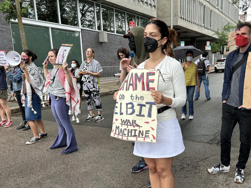 This summer, students like Lesley University junior Soledad Dolorico (purple pants and red keffiyeh) have been joining weekly demonstrations run by BDS Boston (Boycott, Divestment, Sanctions) outside the Cambridge, Mass., offices of Elbit Systems, a defense technology company supplying products to the Israeli military. 