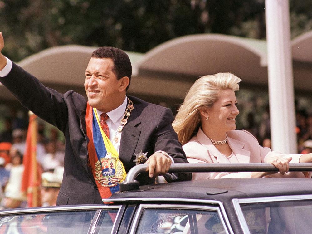 Then-Venezuelan President Hugo Chávez, accompanied by his wife Marisabel Rodríguez de Chávez, waves to supporters as he arrives to preside over a parade in his honor on Feb. 4, 1999. Hugo Chávez died in 2013.