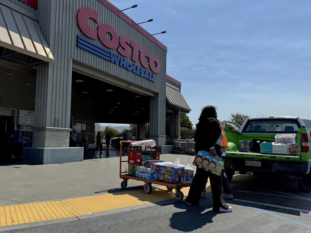 A customer loads a pickup truck after shopping at a Costco store on July 11 in Richmond, Calif.