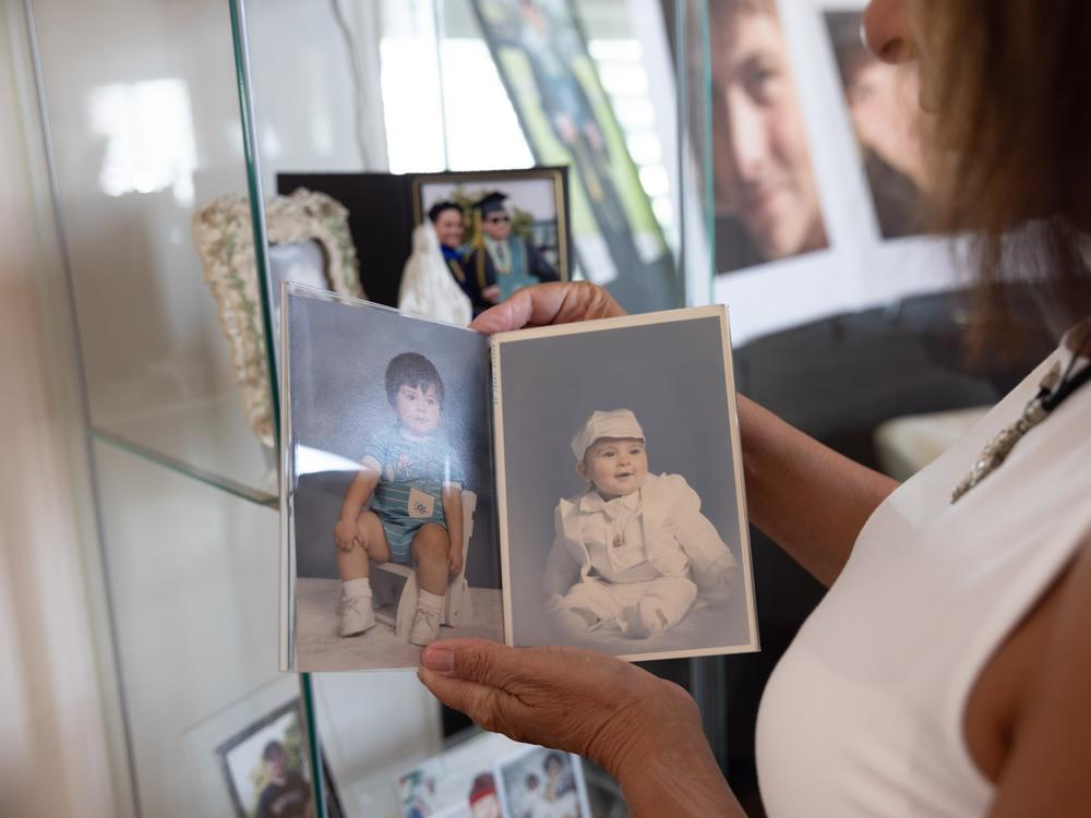 Monica Vera-Schubert looks at baby pictures of Bobby.
