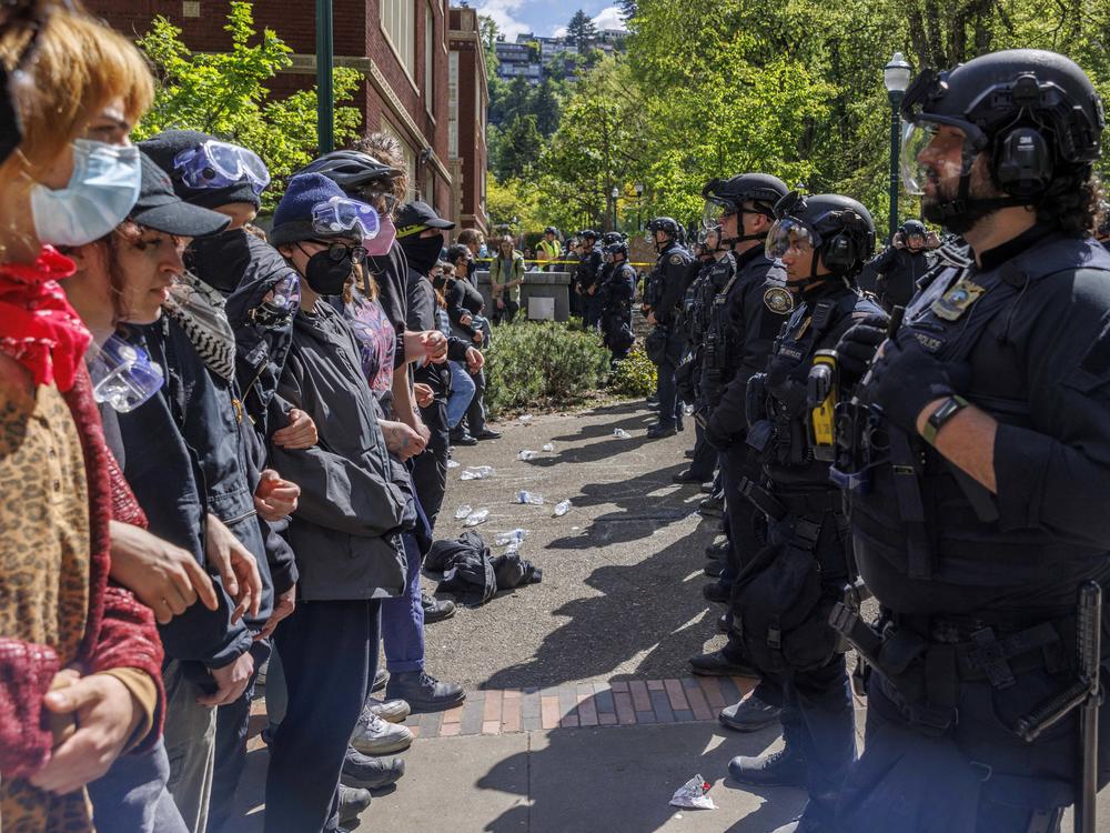 Pro-Palestinian students and activists face police officers after protesters were evicted from the library at Portland State University in Portland, Ore., in May.