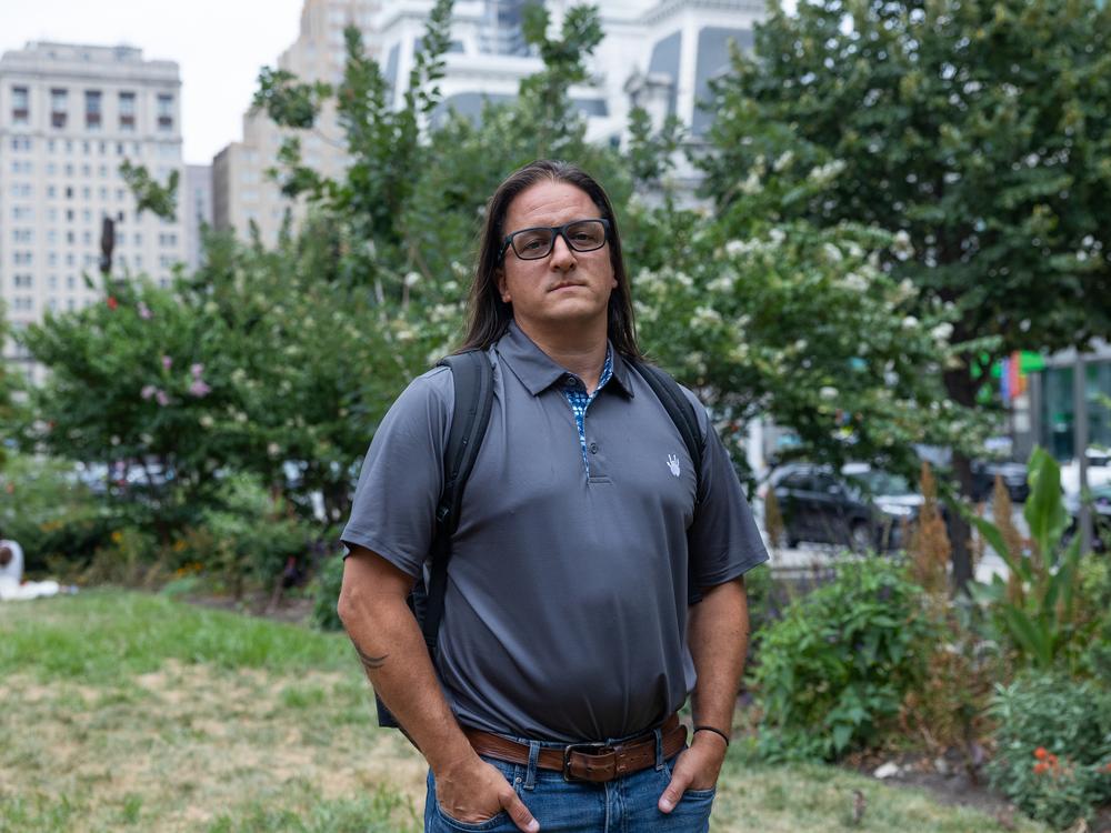 Andrew DiDonato, a construction plan review specialist with Philadelphia's Department of Licenses and Inspections, stands near City Hall on July 22, 2024. After four years of working a hybrid schedule, he's been called back into the office five days a week.