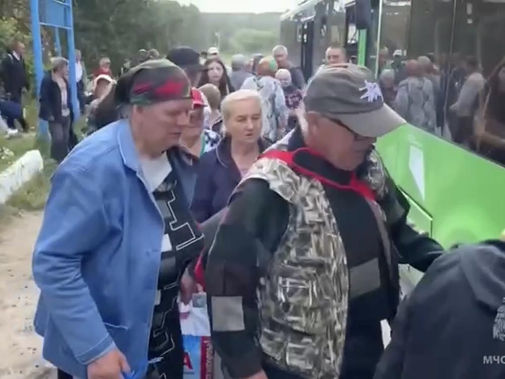 Russians in the western region of Kursk board a bus Monday as part of a large-scale evacuation in the wake of a Ukrainian military operation. Russian officials say more than 100,000 civilians have fled Kursk in the past week.
