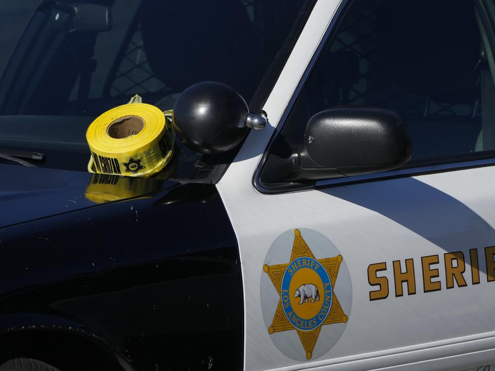 A roll of police tape is left on the windshield of a Los Angeles County sheriff's vehicle. Federal prosecutors allege two former Los Angeles County Sheriff's Department officers took part in an elaborate extortion scheme.