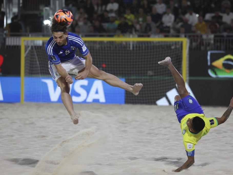 Datinha of Brazil does a bicycle kick Feb. 25 as Italy's Tommaso Fazzini defends during the FIFA Beach Soccer World Cup final between Brazil and Italy at the Dubai Design District Stadium in Dubai, United Arab Emirates.