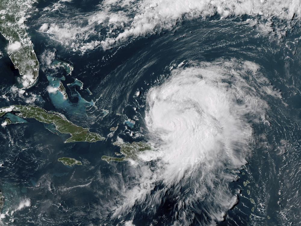 This GOES-16 GeoColor satellite image taken at 4 p.m EDT and provided by National Oceanic and Atmospheric Administration (NOAA) shows Hurricane Ernesto northwest of San Juan, Puerto Rico and moving over open waters, Wednesday, Aug. 14, 2024.