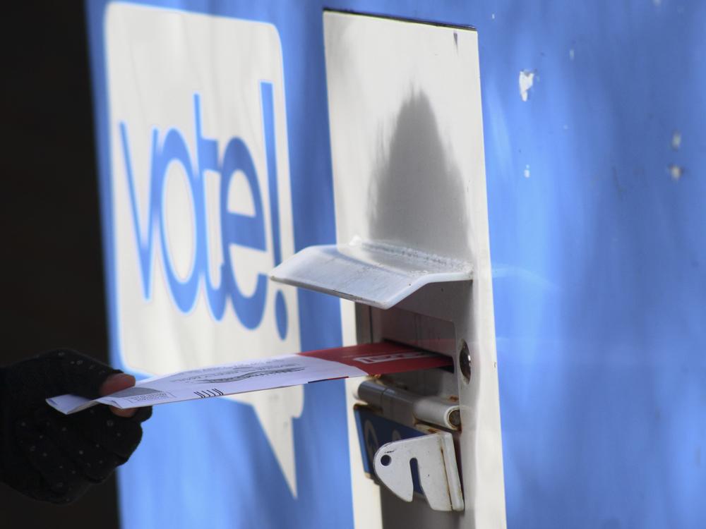In this file photo, a person drops off a ballot at a drop box during the presidential primary election on Tuesday, March 12 in Seattle. Washington state is reliably Democratic in its voting, but its late summer top-two primary has predictive power for how the nation feels about the two main political parties.