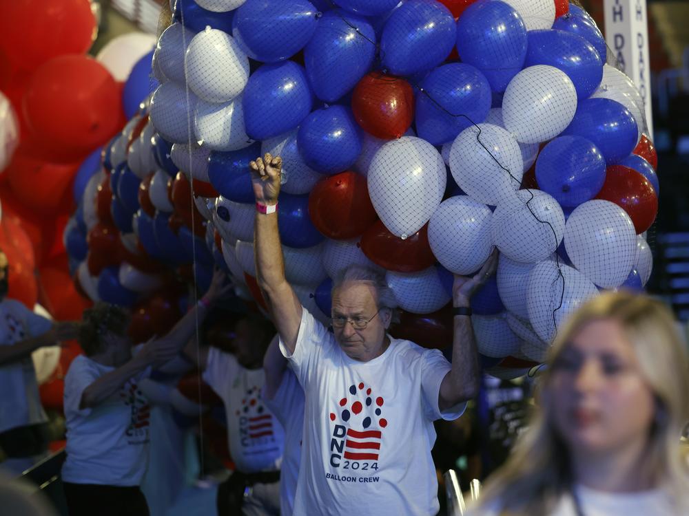 Workers get balloons ready to suspend from the ceiling of the United Center for the Democratic National Convention on Aug. 16 in Chicago.
