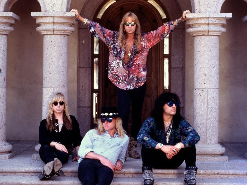Members of the Los Angeles hard-rock group Great White are shown in this undated photo. Standing is Jack Russell.  Seated, from left to right, are Audie Desbrow, Mark Kendall and Michael Lardie.