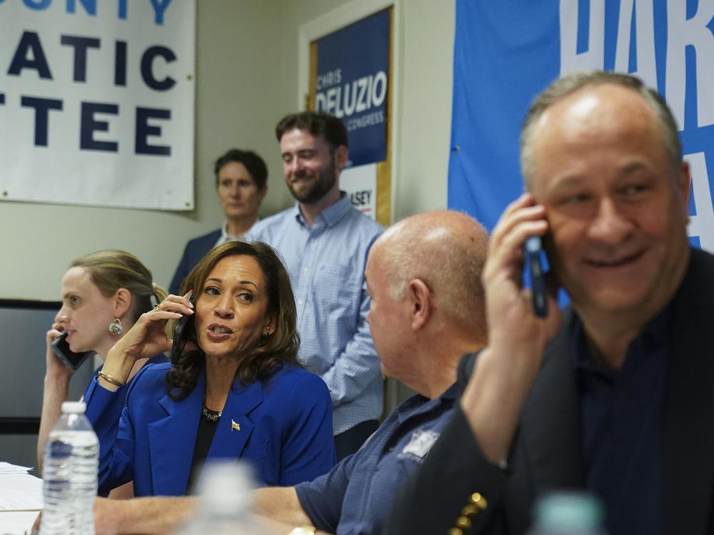 Harris and Emhoff telephone prospective voters from a campaign field office in Rochester, Pa., on Sunday. (Photo by Kevin Lamarque / POOL / AFP via Getty Images)