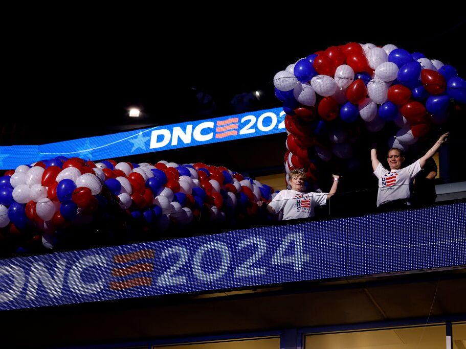 Workers set up balloons before they are lifted above the floor of the United Center for the DNC on Friday in Chicago. The official programming begins Monday.