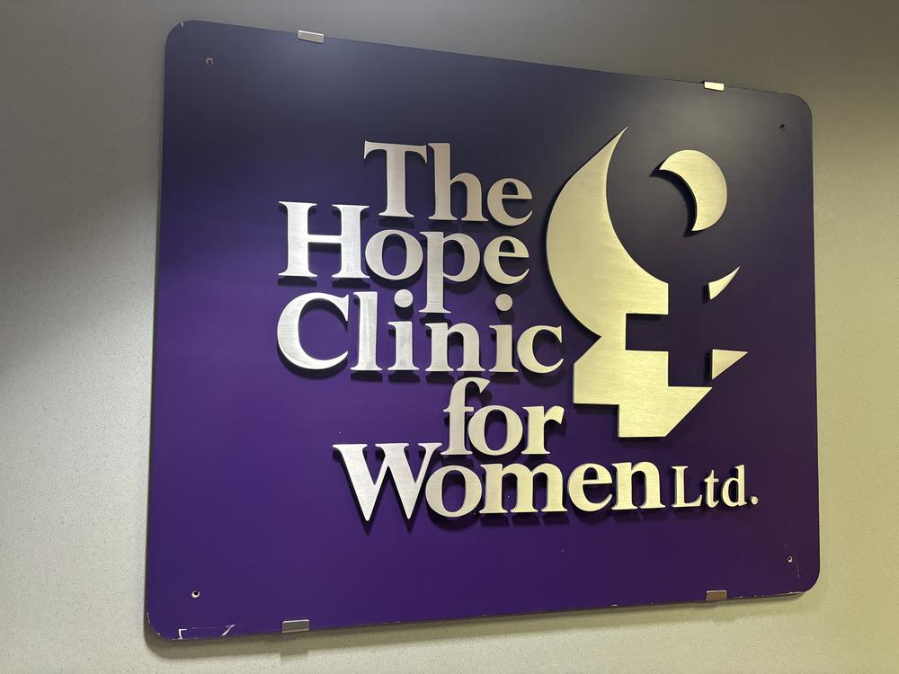 An old sign for the Hope Clinic hangs in one of the clinic’s rooms. The facility recently dropped “for Women” from its name in an effort to include transgender patients. 