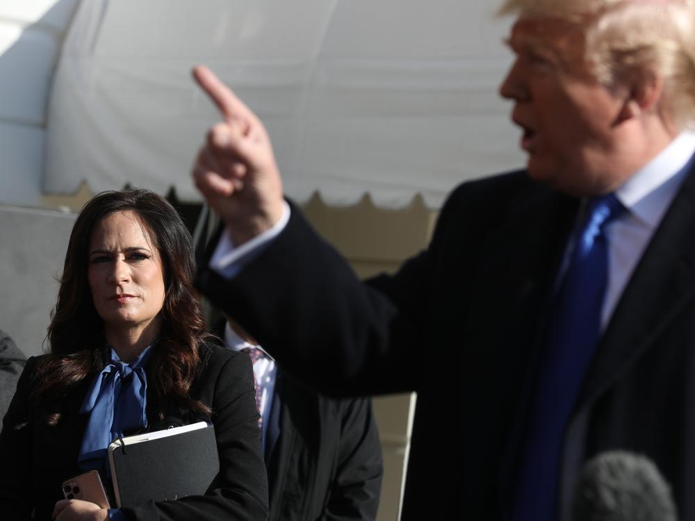 Then-White House Press Secretary Stephanie Grisham (L) listens to U.S. President Donald Trump talk to reporters, November 08, 2019 in Washington, DC.