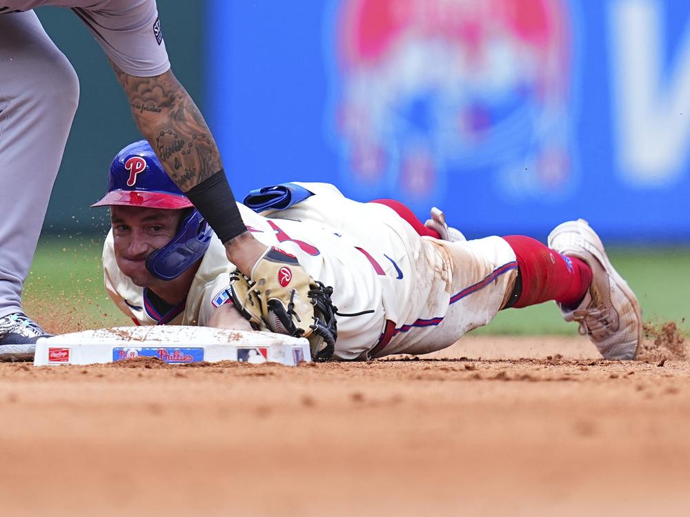 Austin Hays of the Philadelphia Phillies slides in safely past Gleyber Torres of the New York Yankees on July 31, 2024. The Yankees defeated the Phillies 6-5 that day.
