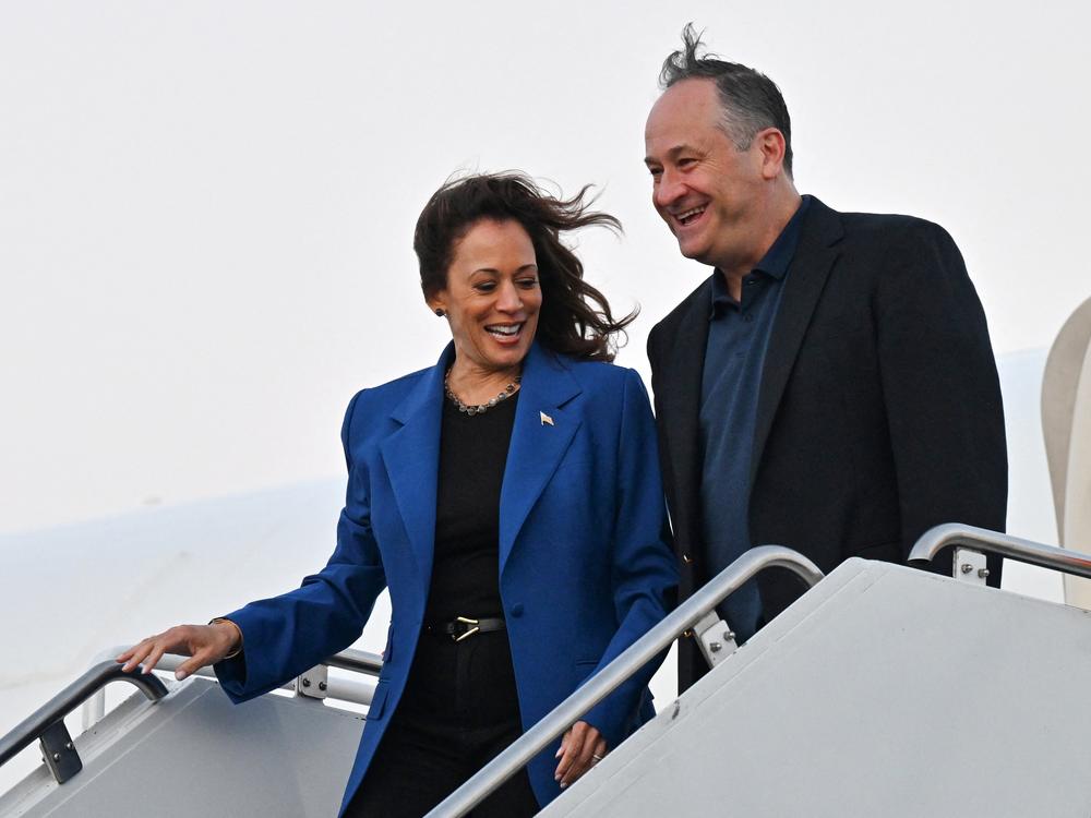 Vice President Harris and second gentleman Doug Emhoff step off Air Force Two in Chicago after a day of campaigning by bus in Pennsylvania on Aug. 18, 2024.