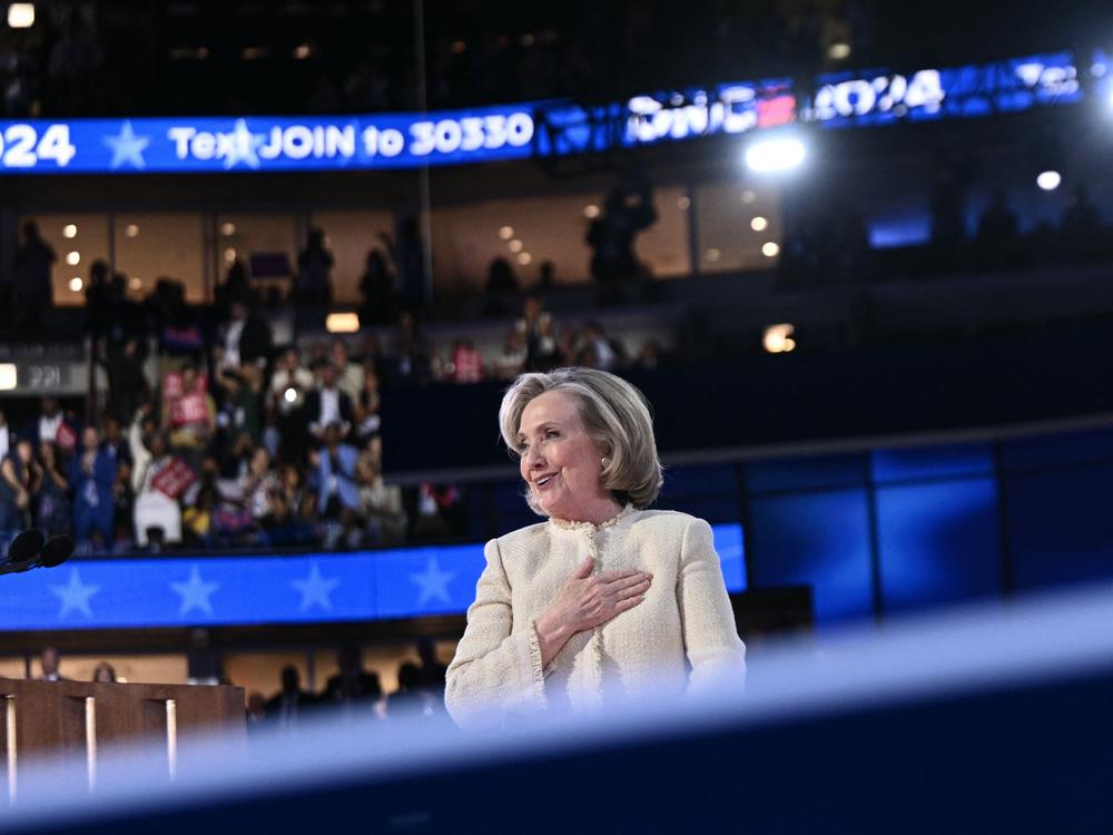 Former US Secretary of State Hillary Clinton salutes the attendees as she steps off stage after speaking on the first day of the Democratic National Convention.