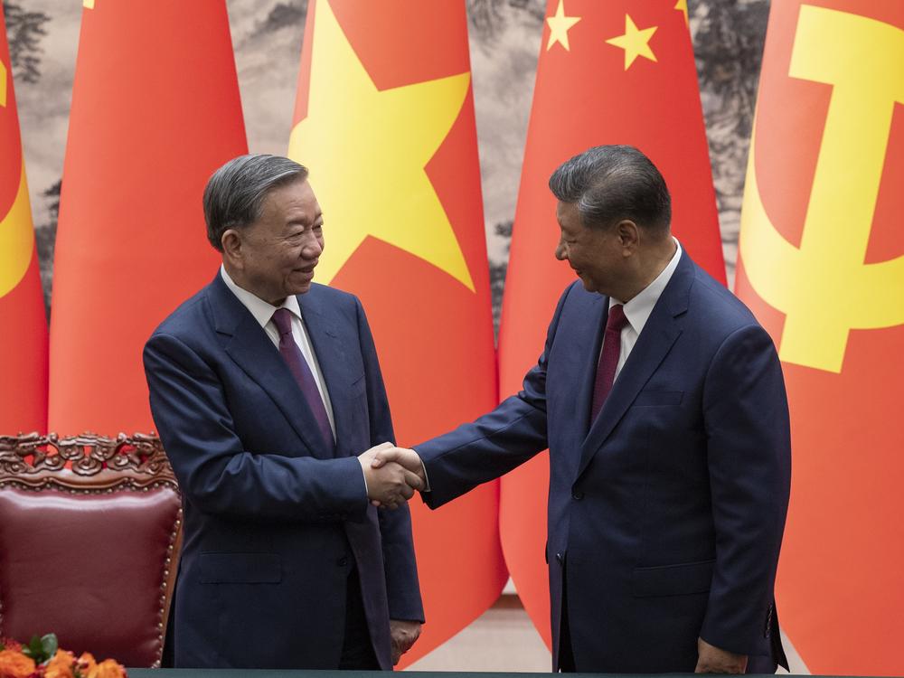 Chinese President Xi Jinping, right, and Vietnam's President To Lam shake hands after a signing ceremony at the Great Hall of the People in Beijing on Monday.