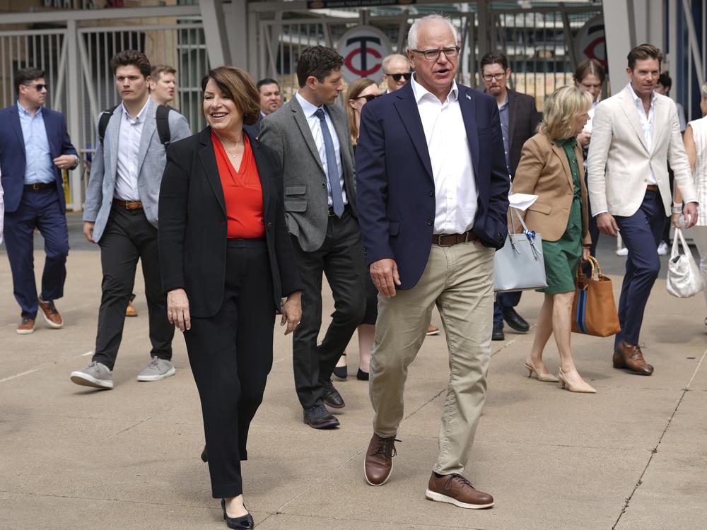 U.S. Senator Amy Klobuchar, left, and Minnesota Gov. Tim Walz, right, arrive at a press conference ahead of the U.S. Gymnastics Olympic Trials on June 24, 2024, in Minneapolis.