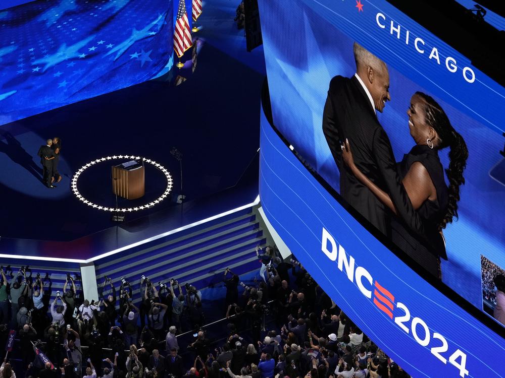 Former President Barack Obama hugs his wife Former first lady Michelle Obama during the Democratic National Convention Tuesday in Chicago.