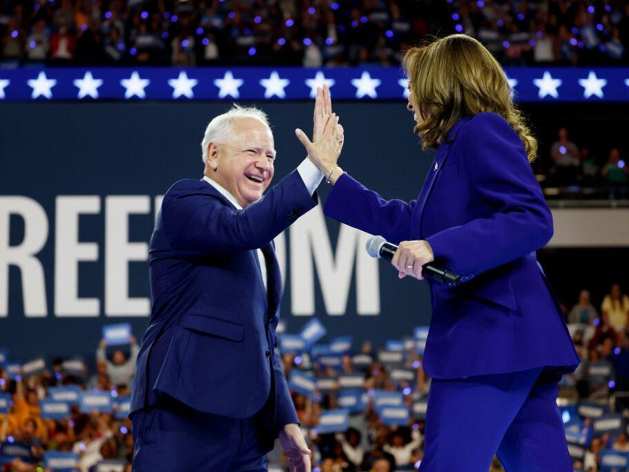 Democratic vice presidential candidate and Minnesota Gov. Tim Walz high-fives presidential nominee Kamala Harris at a campaign rally at the Fiserv Forum on Tuesday in Milwaukee. 