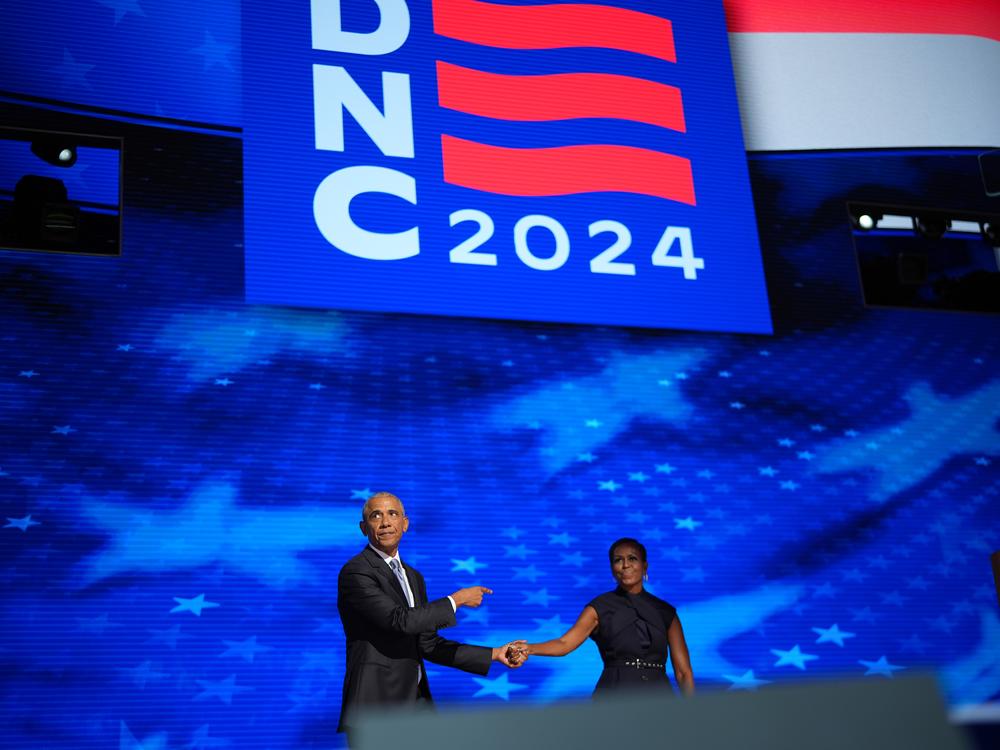 Barack and Michelle Obama share the stage in between their speeches at the DNC.