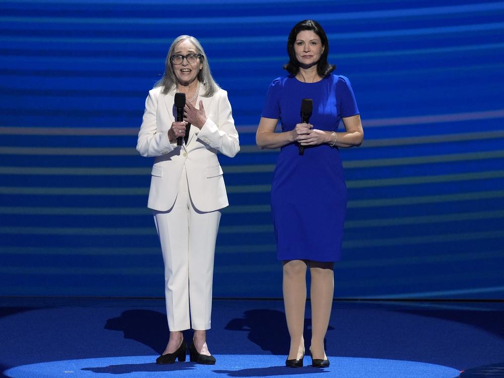 Amy Resner, former prosecutor and friend of Vice President Kamala Harris, left, speaks as Karrie Delaney, director of federal affairs at the Rape, Abuse & Incest National Network, listens at the DNC.